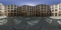 a reflection in the reflection of a building in a fish eye lens of an outside courtyard area