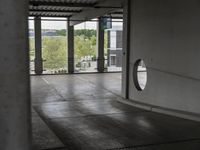 a view through a window at an outdoor area with concrete walls and ceilinging in the background