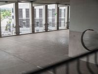 a view through a window at an outdoor area with concrete walls and ceilinging in the background