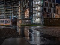 Berlin's Urban Nightscape: A Wet Cobblestone Path