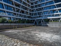 the building has several different angles on it, in varying colors and shapes with brick and concrete floors