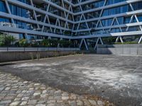 the building has several different angles on it, in varying colors and shapes with brick and concrete floors