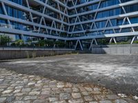 the building has several different angles on it, in varying colors and shapes with brick and concrete floors