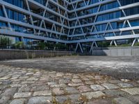 the building has several different angles on it, in varying colors and shapes with brick and concrete floors