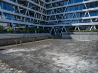 the building has several different angles on it, in varying colors and shapes with brick and concrete floors