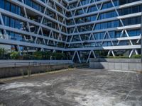 the building has several different angles on it, in varying colors and shapes with brick and concrete floors