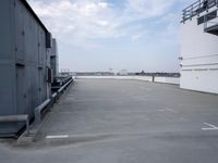 a boat is parked in an empty parking lot near an air port on the water
