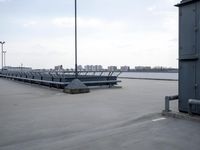 a boat is parked in an empty parking lot near an air port on the water