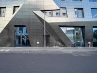 there is a large triangle shaped building that appears to be an inverted structure on a street corner