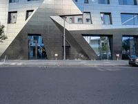 there is a large triangle shaped building that appears to be an inverted structure on a street corner