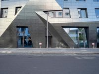 there is a large triangle shaped building that appears to be an inverted structure on a street corner