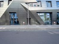 there is a large triangle shaped building that appears to be an inverted structure on a street corner