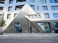 there is a large triangle shaped building that appears to be an inverted structure on a street corner