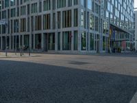 many buildings in the middle of a city with pedestrians walking and parked bikes on the street