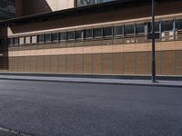 a man that is on a skateboard next to a building with wooden panels on it