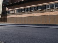 a man that is on a skateboard next to a building with wooden panels on it