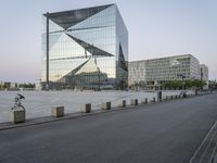 a cyclist is walking next to the building near the river in the city of copenhagen