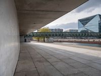 there is an empty walkway between two buildings by the water on this cloudy day in this photo