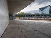 there is an empty walkway between two buildings by the water on this cloudy day in this photo