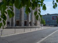 an entrance of a building with large columns and doors that spell out the word voltege