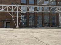 an old industrial warehouse with a lot of windows and doors outside the building that sits on top of it