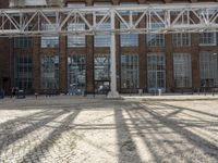 an old industrial warehouse with a lot of windows and doors outside the building that sits on top of it