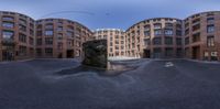 a photo looking at the bottom of a fountain in the middle of a courtyard area