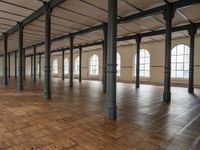 a large open room with wooden flooring and exposed ceilings in it is clean, well lit and ready to be used as an office