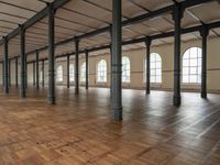 a large open room with wooden flooring and exposed ceilings in it is clean, well lit and ready to be used as an office