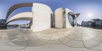 a fish - eye view of the exterior of a building on the water's edge