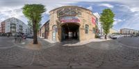 this is an 360 - angle photograph looking into a building on a sunny day with clouds above