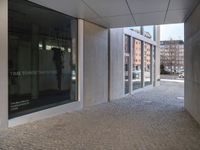 a piece of tape lies on the floor outside a large building with a clock and the door