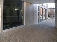 a piece of tape lies on the floor outside a large building with a clock and the door