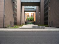 an open air gate outside a building next to a street and trees in a city