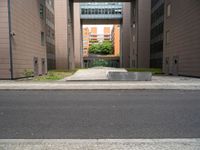 an open air gate outside a building next to a street and trees in a city