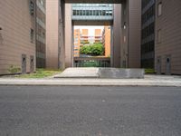 an open air gate outside a building next to a street and trees in a city