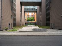 an open air gate outside a building next to a street and trees in a city