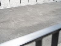 an image of a man riding a motorcycle on the side of the street in a parking lot