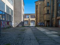 an alley in the town of hamburg, germany with lots of graffiti on it's walls