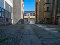 an alley in the town of hamburg, germany with lots of graffiti on it's walls