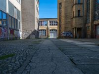 an alley in the town of hamburg, germany with lots of graffiti on it's walls