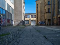 an alley in the town of hamburg, germany with lots of graffiti on it's walls