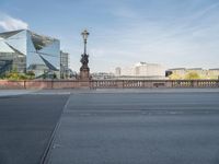 a street light and a view of a building on a bridge over the water in europe