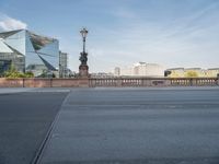 a street light and a view of a building on a bridge over the water in europe