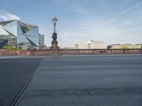 a street light and a view of a building on a bridge over the water in europe