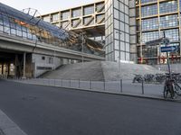 bike parked in front of the modern glass and steel building in a european city area