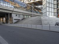 bike parked in front of the modern glass and steel building in a european city area