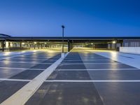 this parking garage is empty of any cars at night or night time or night,