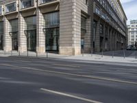 an empty city street with tall buildings and two streetscapes next to each other