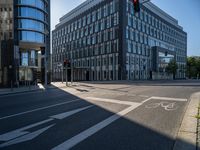 a very modern building with glass windows on either side, and bicycle lane on the right